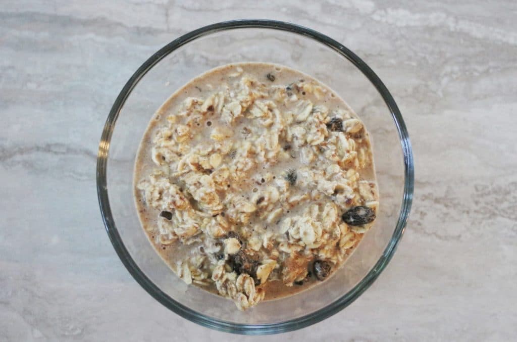 making overnight oats in a glass bowl