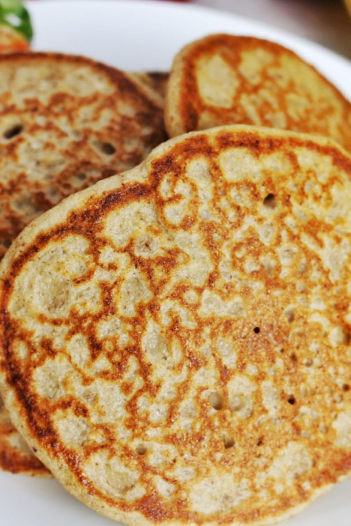 close up view of three pancakes showing the bubbles