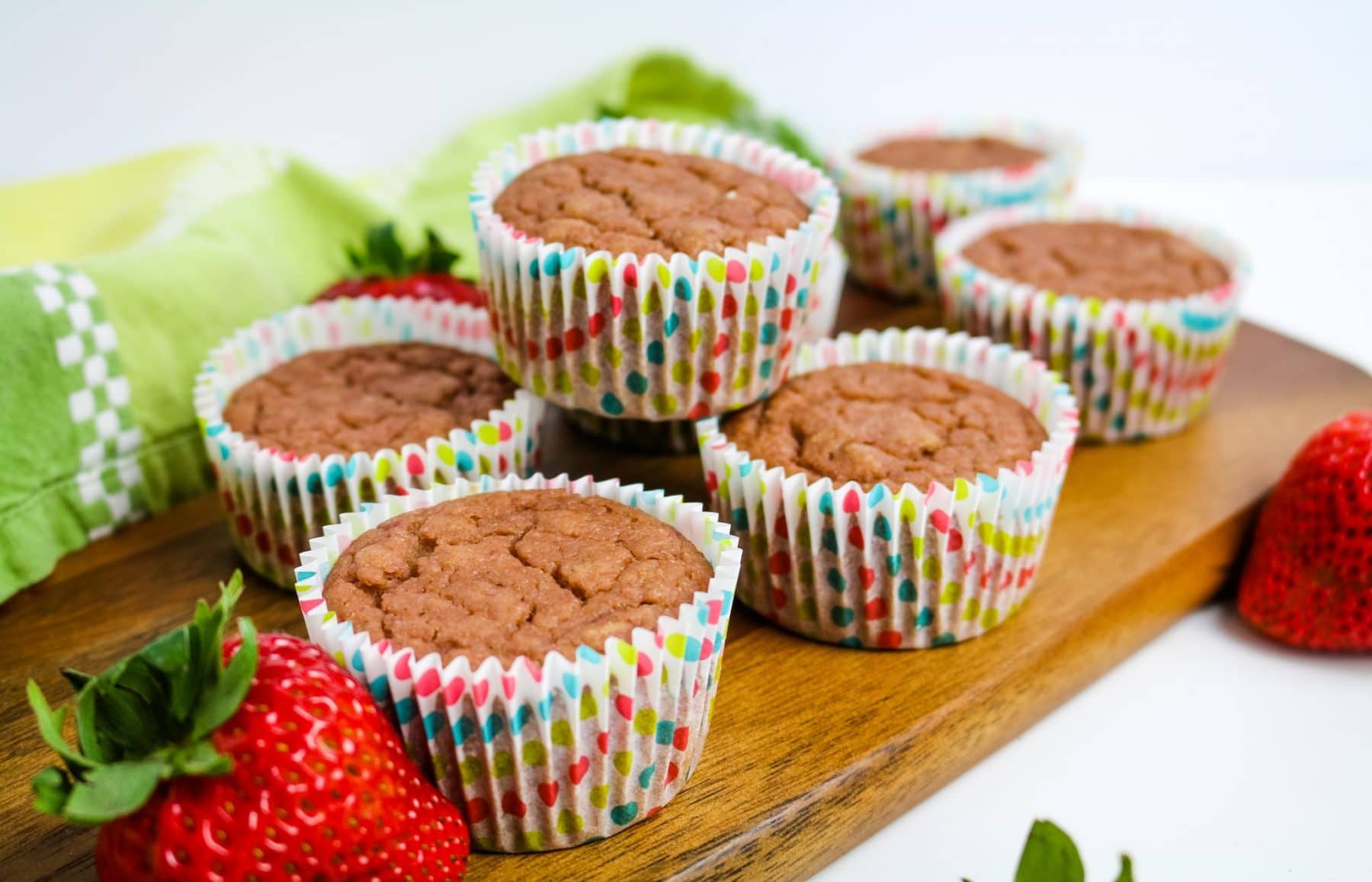strawberry muffins arranged on a board