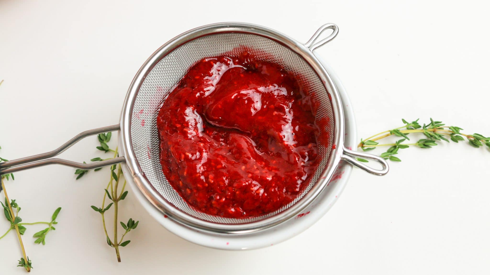 berry puree in a sieve