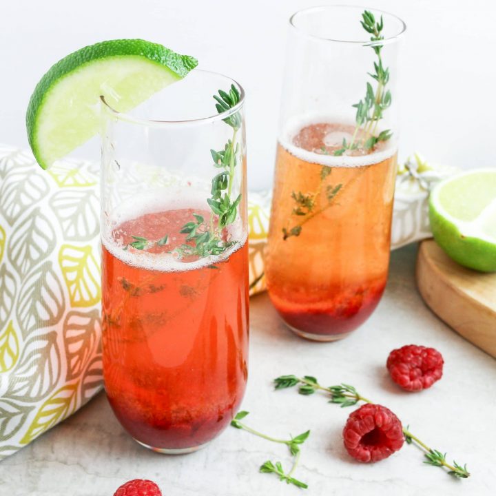 picture of berry champagne cocktails with thyme sprig
