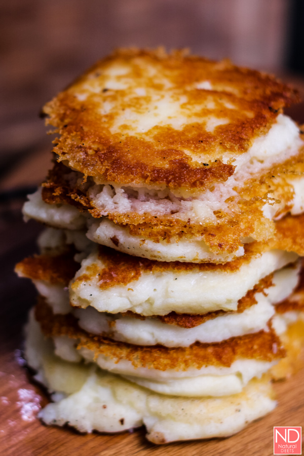 potato cakes stacked on a cutting board
