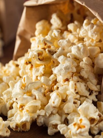 side view of popcorn coming out of a paper bag