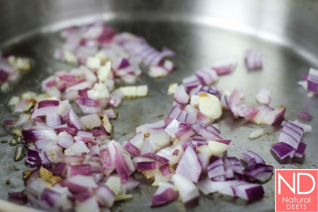 chopped red onions in a saute pan with olive oil