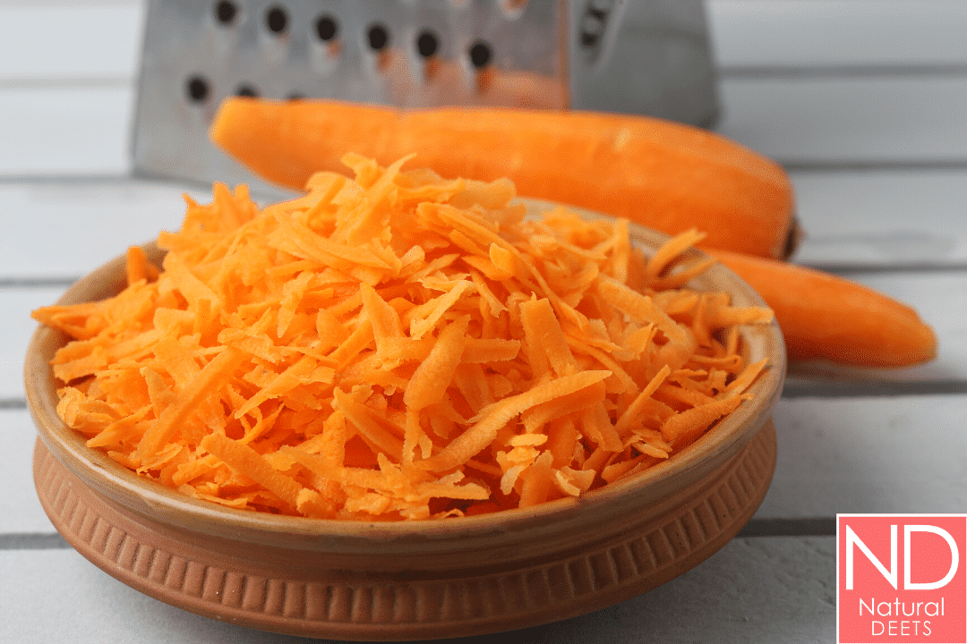 a pile of grated carrots on a mason jar lid