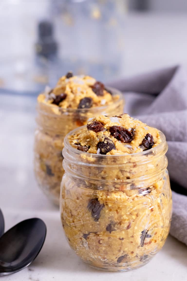 a glass jar with edble cookie dough. It looks like chocolate chip dough but it actually has raisins