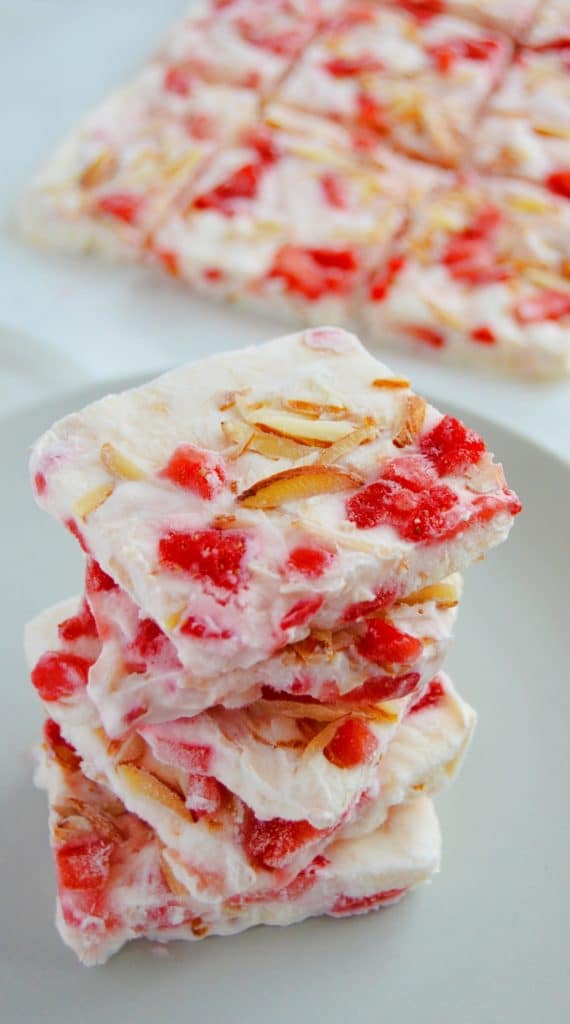frozen yogurt squares stacked on each other with strawberries