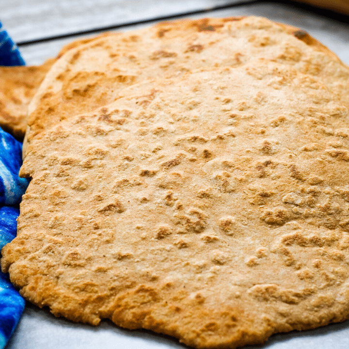 picture of the flatbread on a marble table with a blue napkin