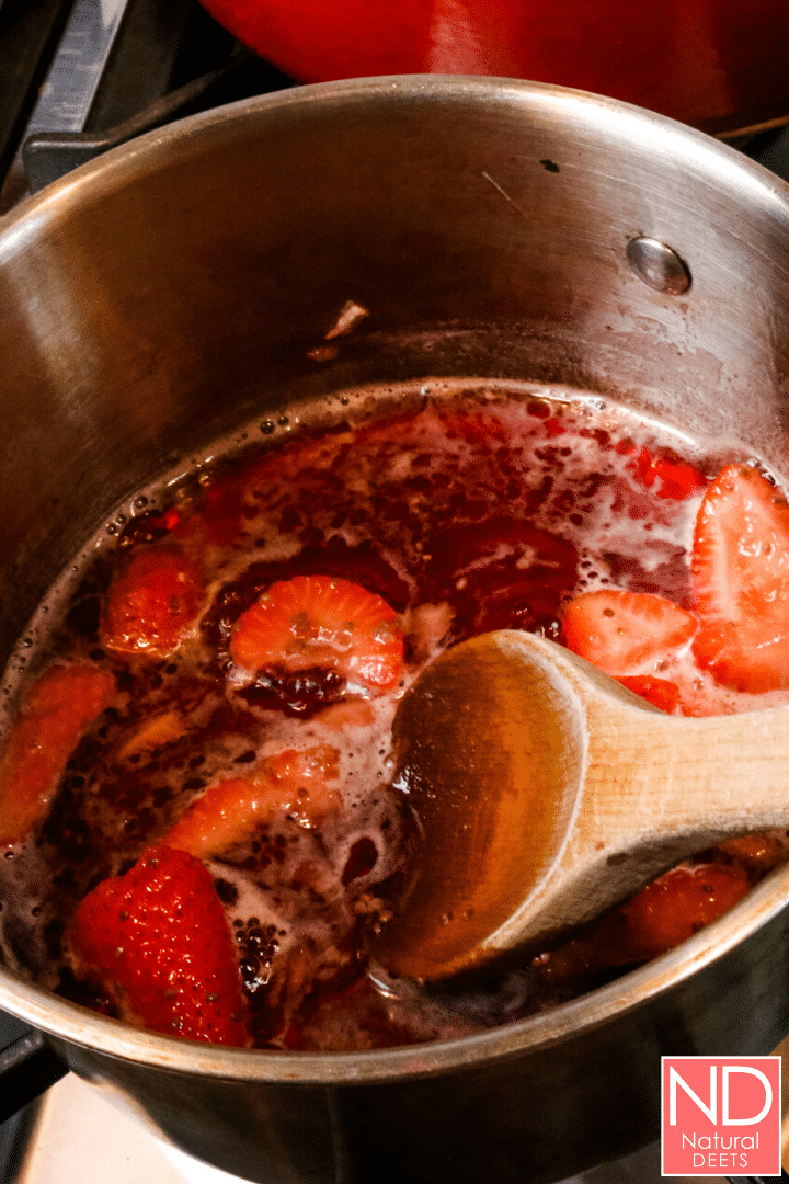 top down view of a saucepan with the juice and fruits as the fruits soften