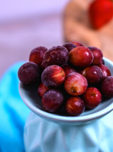 frozen grapes on a light blue platter with a bright blue napkin in the background
