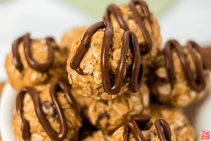 a stack of energy balls with chocolate drizzle