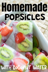 fruit popsicles with kiwis and strawberries showing in a bowl of ice