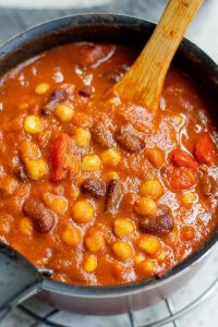 top view of a pot with chili showing beans, corn and tomatoes
