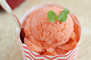 a scoop of strawberry sorbet in a cup