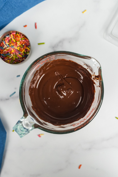 a top view of melted chocolate in a glass pyrex measuring bowl