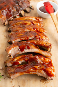 side view of ribs cut up and lined up on a wooden cutting board