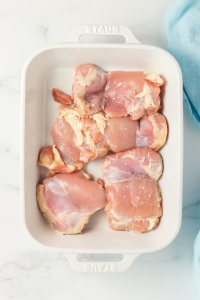 top view of chicken thighs in a white casserole dish