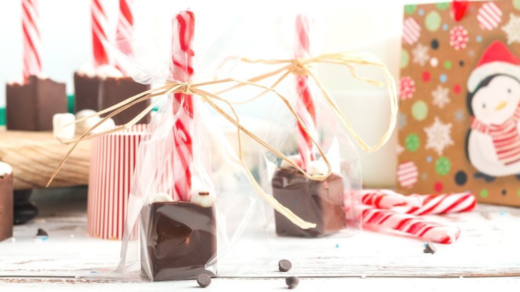 side view of the chocolate spoon in a clear gift bag with a tie on the top