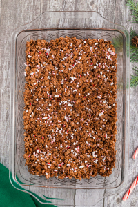 top view of a pan with the rice krispie pressed in and sprinkled with crushed candy canes