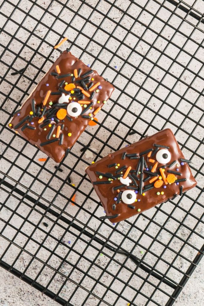 chocolate covered rice krispie squares with sprinkles and eye balls