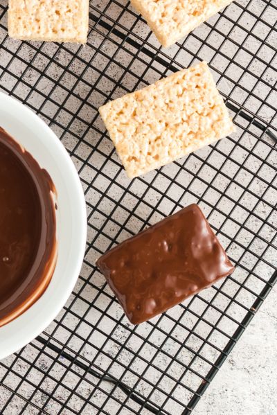 a chocolate covered rice krispie treat on a cooling rack