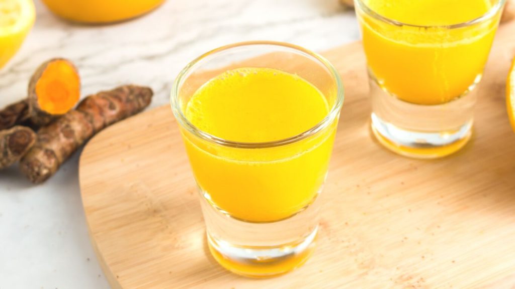 side view of a yellow liquid in a clear shot glass