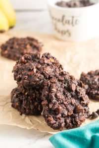 a stack of three brown chocolate breakfast cookies with one leaning against the stack