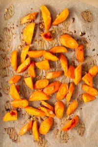 top view of roasted carrot pieces on brown parchment paper