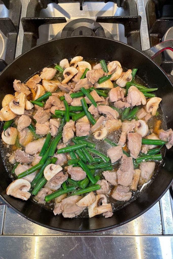 top view of chicken and green beans in skillet