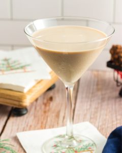 side view of a martini glass with chocolate milk colored cocktail