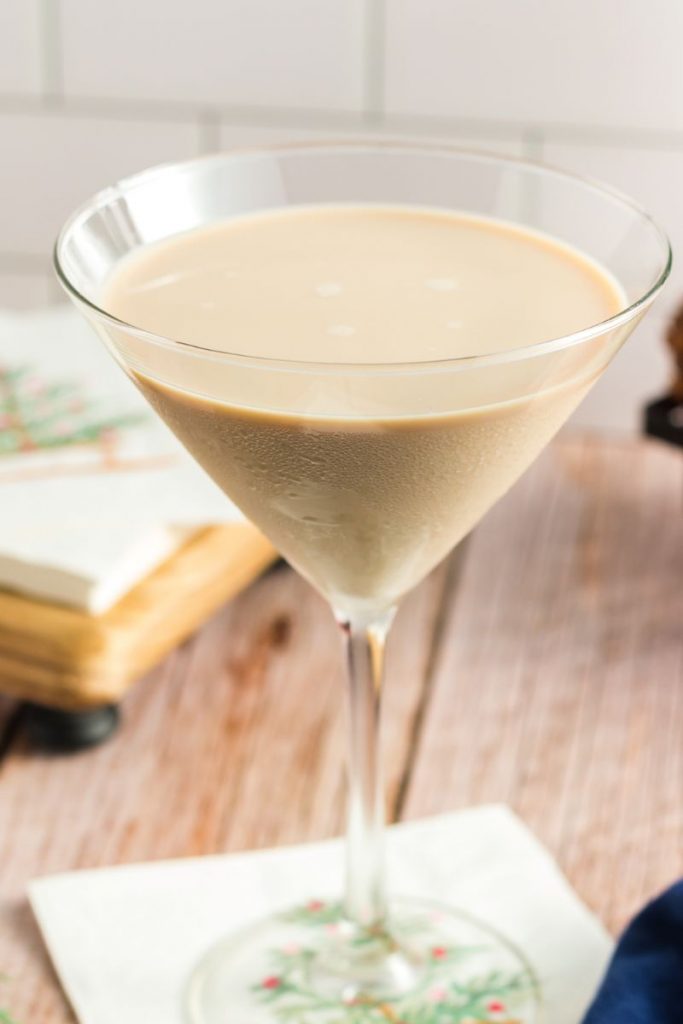side view of a martini glass with a brown milky cocktail