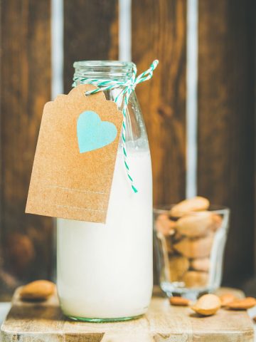 picture of nut milk in a glass jug with a brown tag that has a heart on it