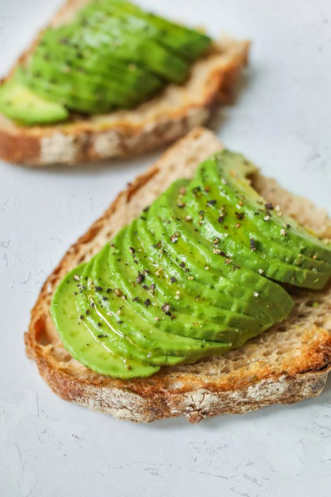 Sliced avocado on whole grain toast with seasoning – dairy-free butter alternative