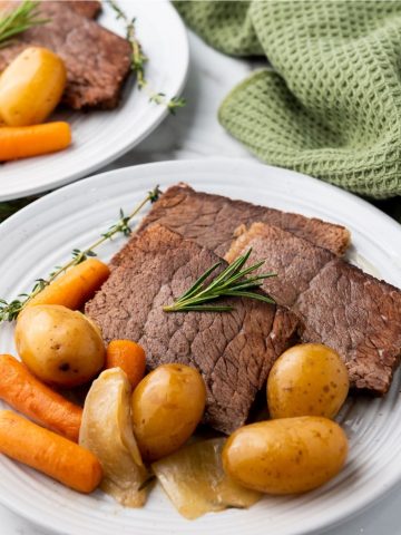 slices of cooked roast beef with potatoes